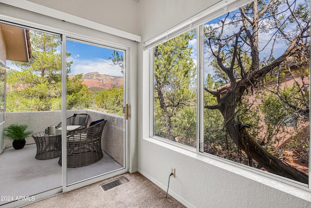 sunroom with a healthy amount of sunlight and a mountain view