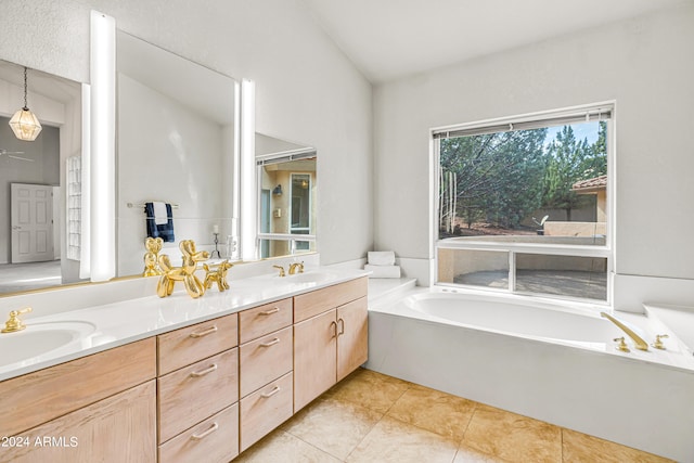 bathroom featuring a tub to relax in, tile patterned flooring, and vanity