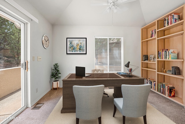 office featuring lofted ceiling, a healthy amount of sunlight, and carpet floors