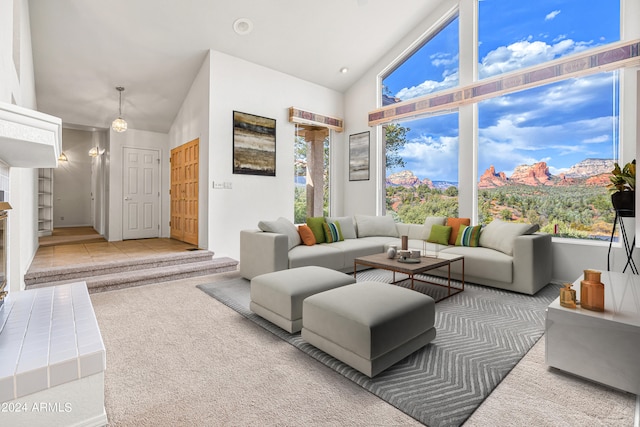 living room with high vaulted ceiling and carpet