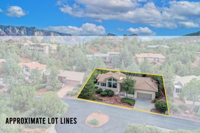 birds eye view of property with a mountain view