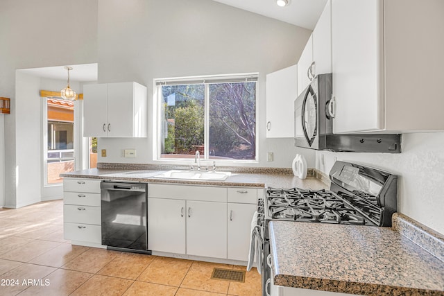 kitchen featuring high vaulted ceiling, sink, hanging light fixtures, white cabinets, and appliances with stainless steel finishes