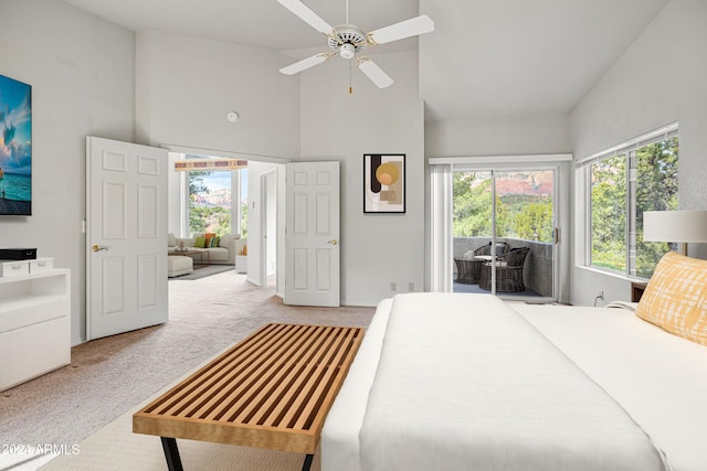 carpeted bedroom with access to outside, high vaulted ceiling, and ceiling fan