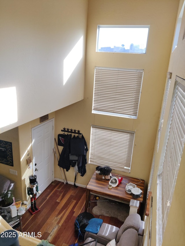 office space featuring dark hardwood / wood-style flooring and a high ceiling