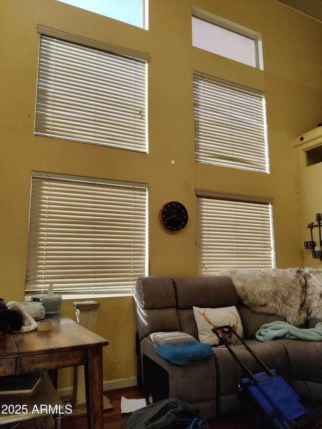 living room featuring a towering ceiling