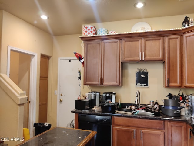 kitchen with black dishwasher, sink, and dark stone countertops