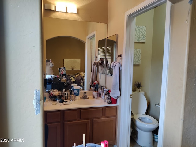 bathroom with vanity and toilet