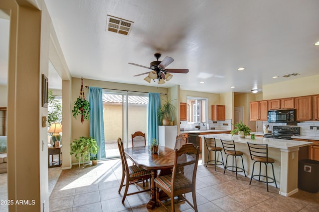 dining room with light tile patterned floors, visible vents, and recessed lighting