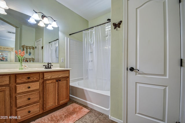 bathroom with double vanity, shower / tub combo with curtain, a sink, tile patterned flooring, and a notable chandelier