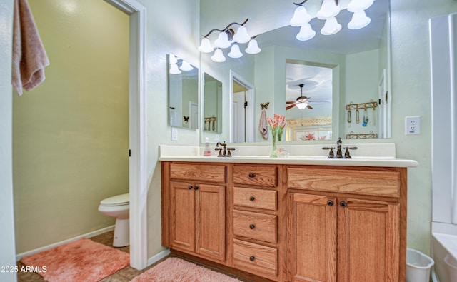 bathroom with ceiling fan, toilet, a sink, tile patterned floors, and double vanity