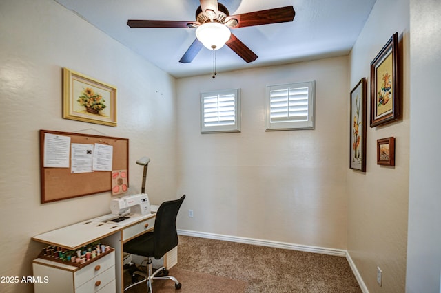 carpeted home office featuring a ceiling fan and baseboards