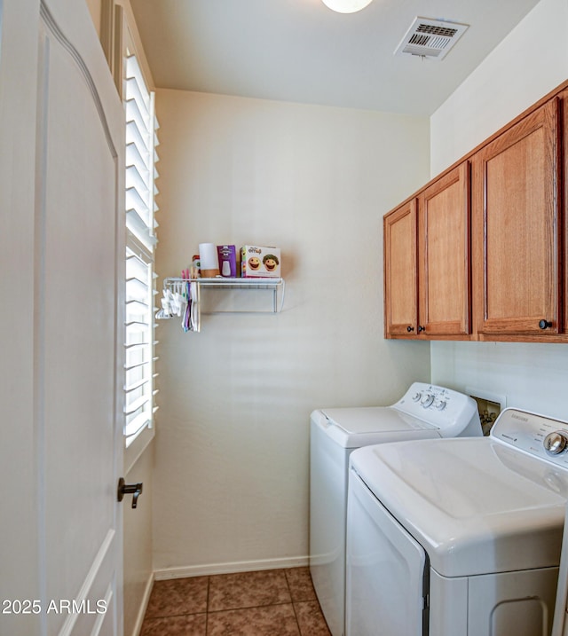 laundry area featuring cabinet space, light tile patterned floors, baseboards, visible vents, and washer and dryer