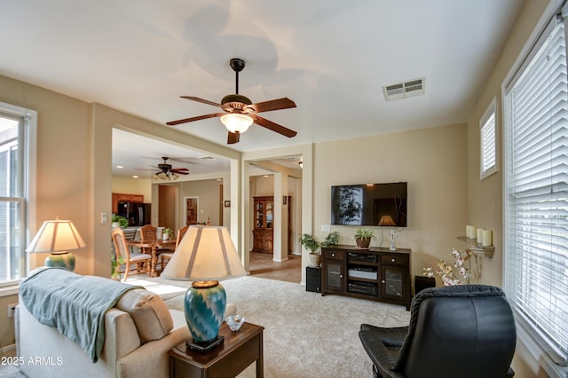 living area with visible vents and carpet flooring