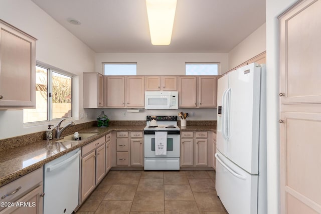 kitchen featuring a wealth of natural light, sink, white appliances, and light brown cabinets