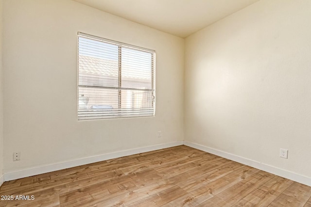 unfurnished room featuring light wood-type flooring and baseboards