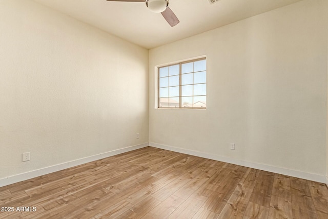 unfurnished room featuring light wood-type flooring, ceiling fan, and baseboards