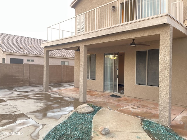 view of patio / terrace featuring a balcony, a ceiling fan, and fence