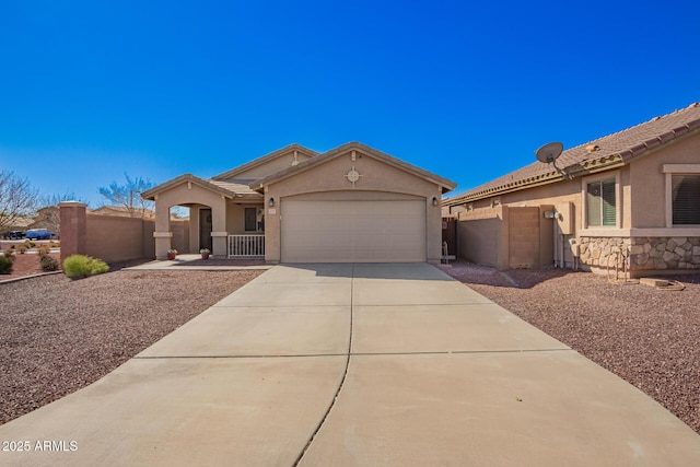 view of front of property with stucco siding, an attached garage, a gate, fence, and driveway