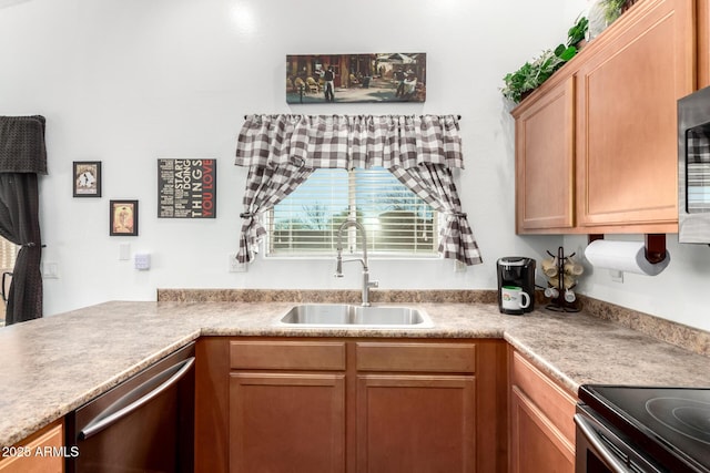 kitchen featuring light countertops, stainless steel dishwasher, and a sink