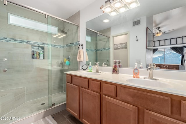 bathroom featuring a shower stall, visible vents, and a sink