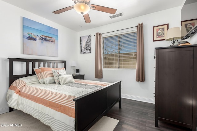 bedroom with ceiling fan, dark wood finished floors, visible vents, and baseboards