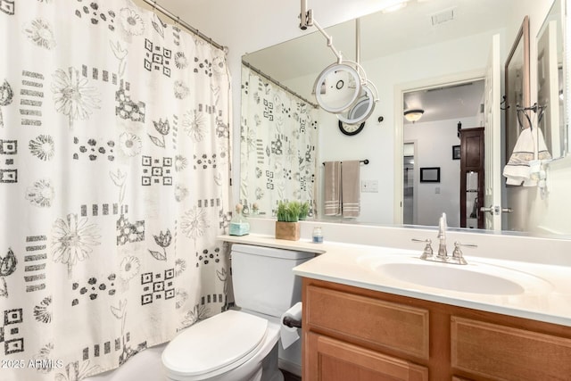 bathroom featuring visible vents, vanity, and toilet