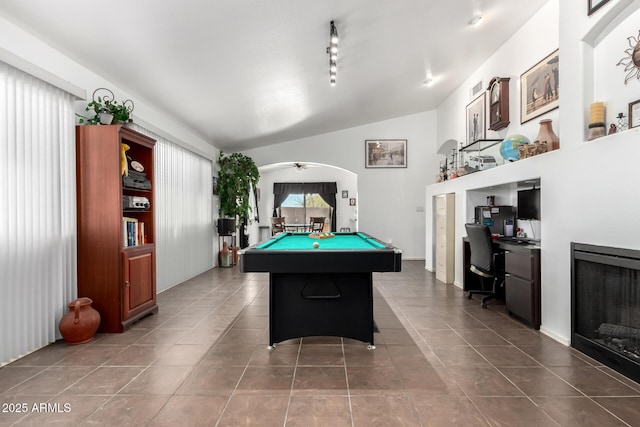 recreation room with dark tile patterned flooring, lofted ceiling, pool table, built in desk, and track lighting