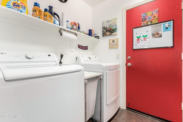 laundry room featuring laundry area, dark tile patterned floors, and independent washer and dryer