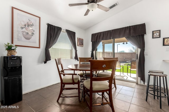 dining area with visible vents, baseboards, vaulted ceiling, a ceiling fan, and tile patterned floors