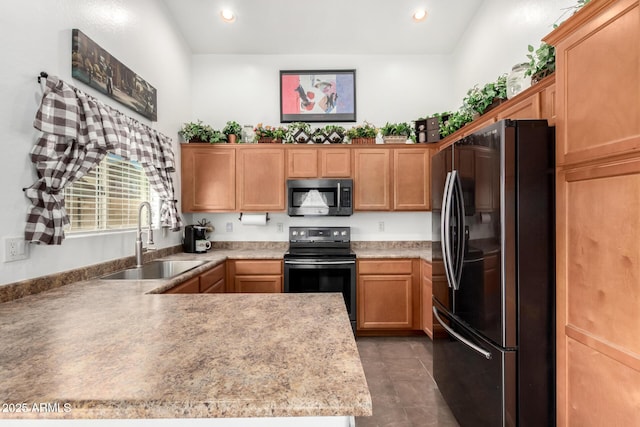 kitchen featuring electric stove, light countertops, stainless steel microwave, freestanding refrigerator, and a sink