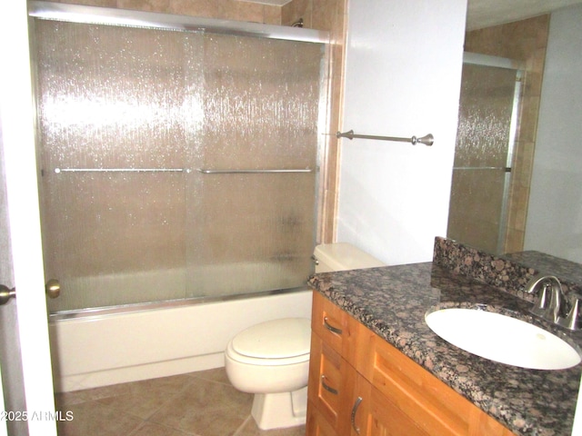 full bathroom featuring vanity, tile patterned flooring, bath / shower combo with glass door, and toilet