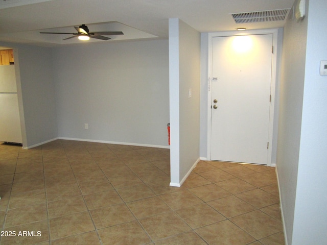 interior space with light tile patterned floors and ceiling fan