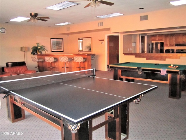 recreation room featuring bar and ceiling fan