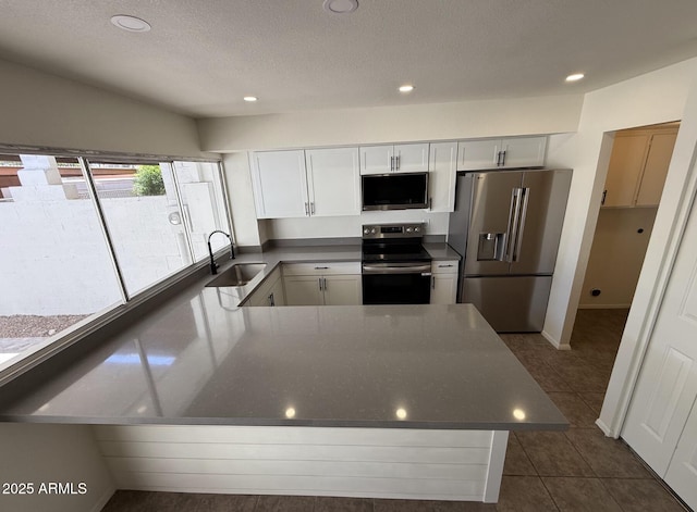 4849 W Northern Ave, Glendale, AZ 85301 - kitchen featuring stainless steel appliances, a peninsula, recessed lighting, dark countertops, and dark tile patterned floors