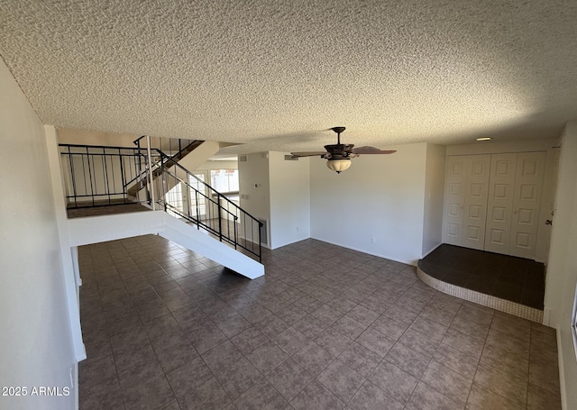 4849 W Northern Ave, Glendale, AZ 85301 - unfurnished living room featuring a textured ceiling, stairs, ceiling fan, and tile patterned floors