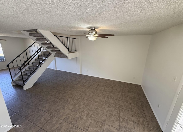 4849 W Northern Ave, Glendale, AZ 85301 - empty room with ceiling fan, stairs, a textured ceiling, and dark tile patterned flooring
