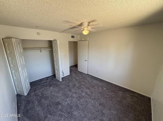 4849 W Northern Ave, Glendale, AZ 85301 - unfurnished bedroom with a closet, dark colored carpet, a textured ceiling, and ceiling fan