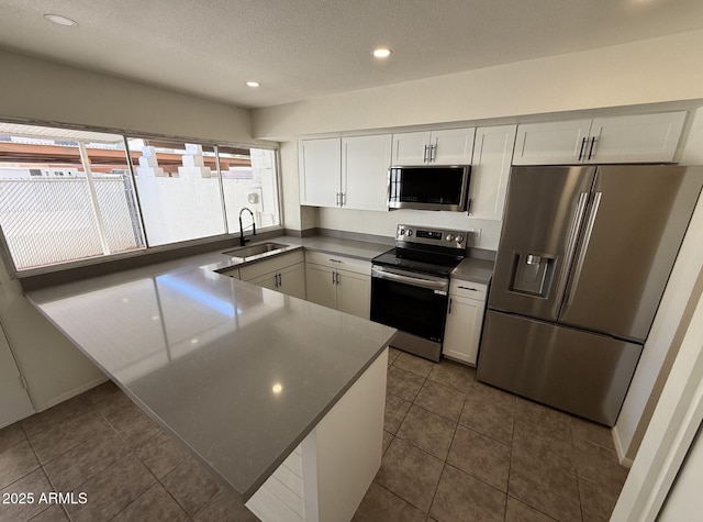 4849 W Northern Ave, Glendale, AZ 85301 - kitchen featuring appliances with stainless steel finishes, white cabinetry, recessed lighting, dark countertops, and a textured ceiling