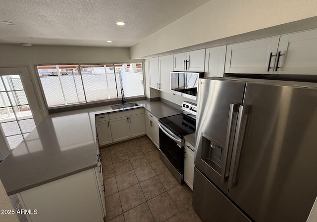 4849 W Northern Ave, Glendale, AZ 85301 - kitchen featuring appliances with stainless steel finishes, a textured ceiling, white cabinets, dark tile patterned floors, and recessed lighting