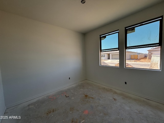 46869 W Old Timer Rd, Maricopa, AZ 85139 - spare room featuring concrete floors and baseboards