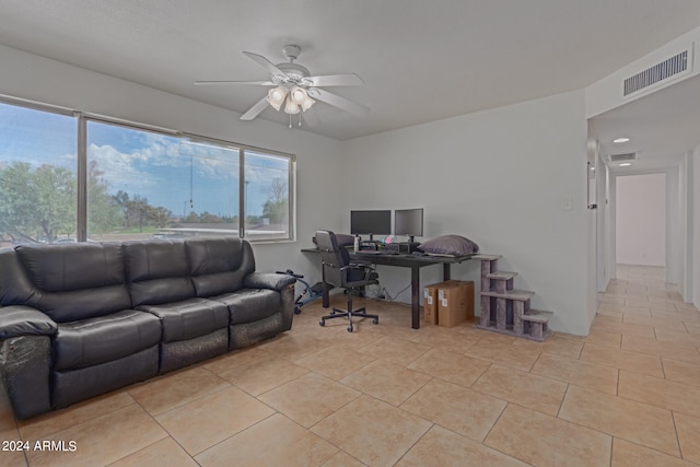 office area with light tile patterned floors and ceiling fan