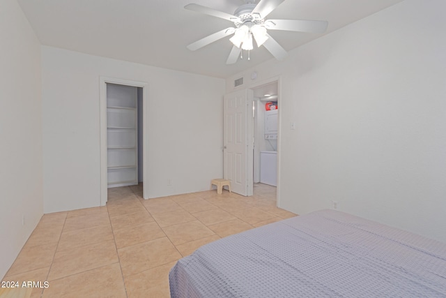 tiled bedroom featuring ceiling fan