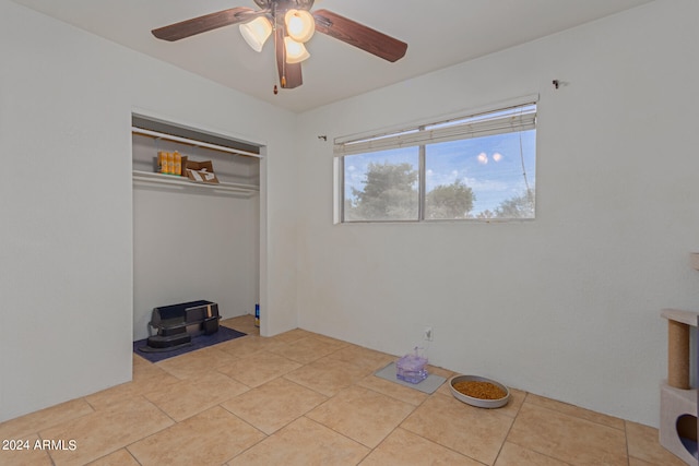 unfurnished bedroom featuring a closet, ceiling fan, and light tile patterned floors