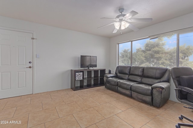 tiled living room featuring ceiling fan