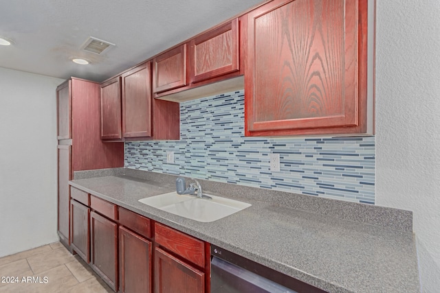 kitchen with decorative backsplash, dishwasher, light tile patterned floors, and sink