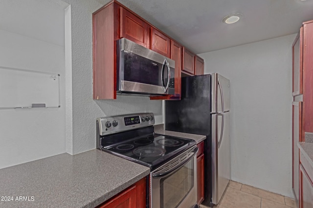 kitchen with stainless steel appliances and light tile patterned floors