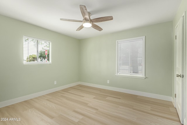 unfurnished room with ceiling fan and light wood-type flooring