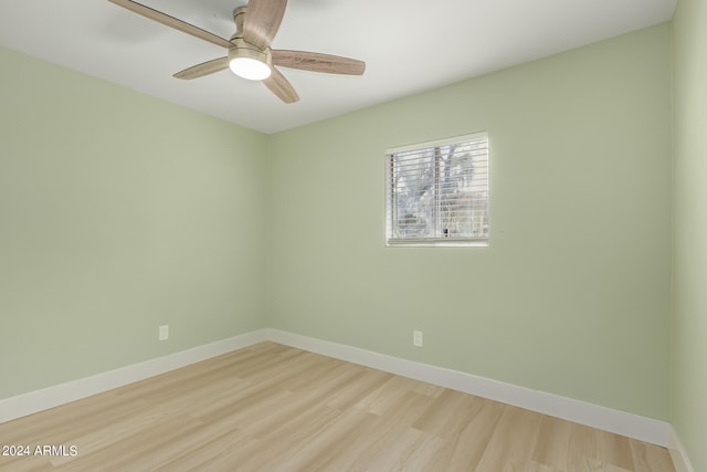 empty room with ceiling fan and light hardwood / wood-style flooring