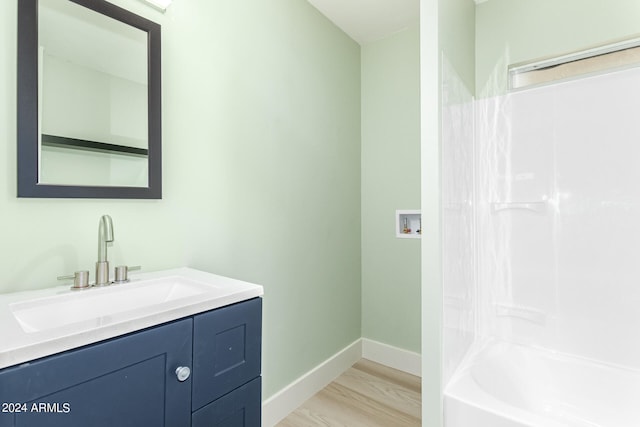 bathroom with vanity, hardwood / wood-style floors, and shower / bath combination