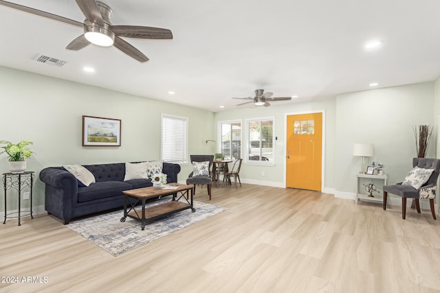 living room featuring ceiling fan and light hardwood / wood-style floors